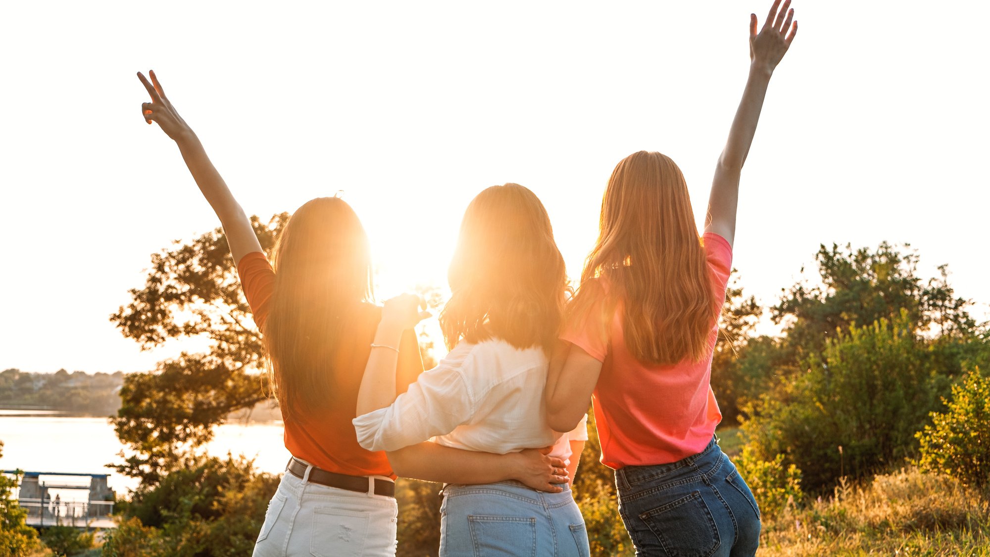 Group of Friends Facing Sunset Outdoors